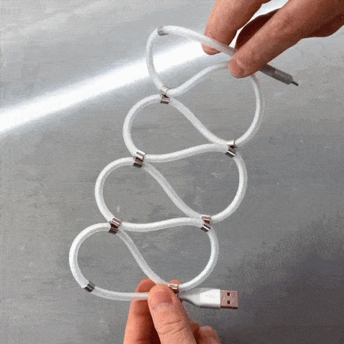 Magnetic self-winding charging cable coiled into a figure-eight